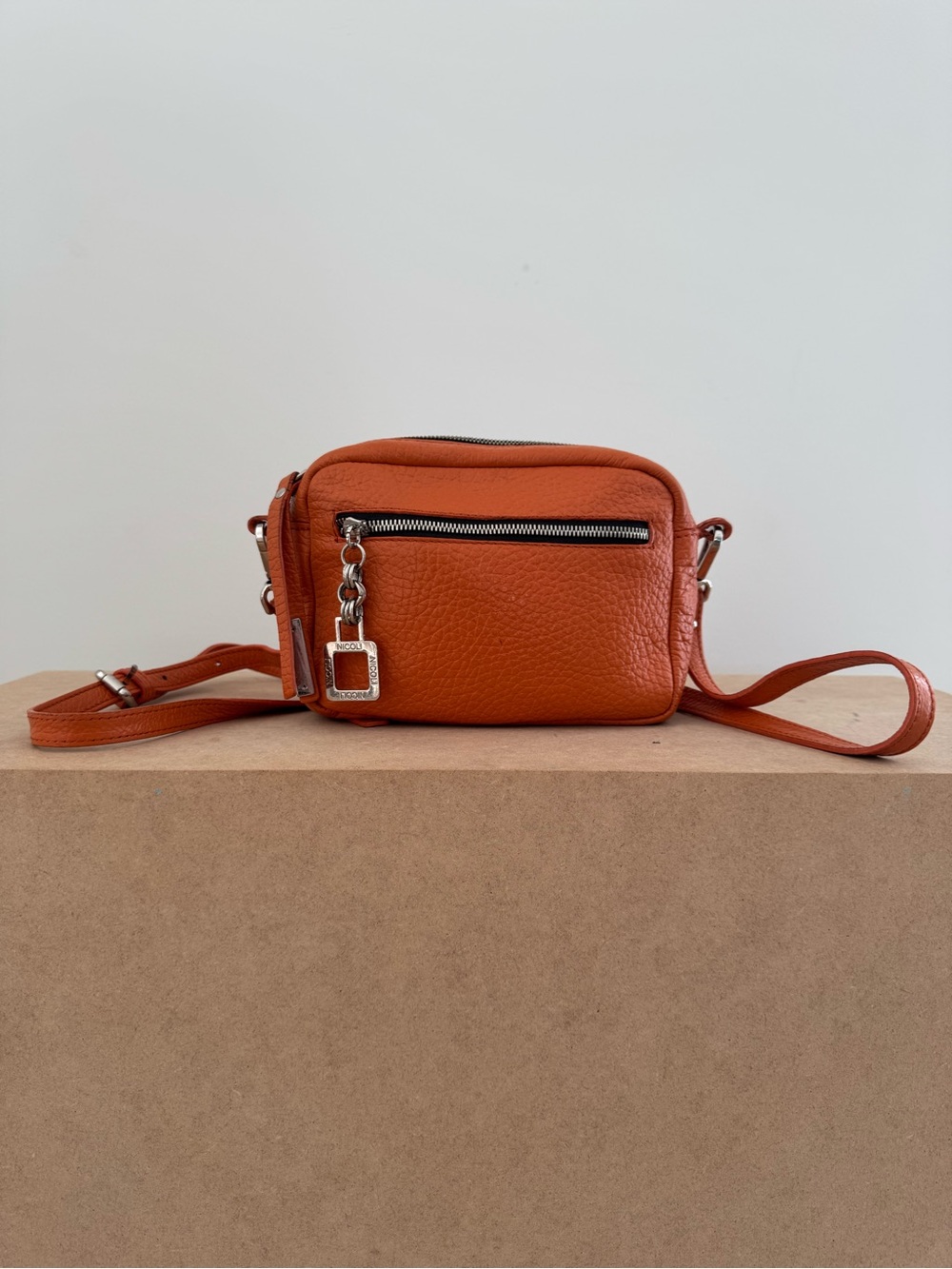 Nicoli Compact Orange Leather Crossbody Bag with Silver Hardware Minimalist